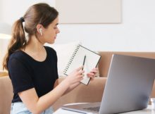 focused woman using laptop while attending online webinar